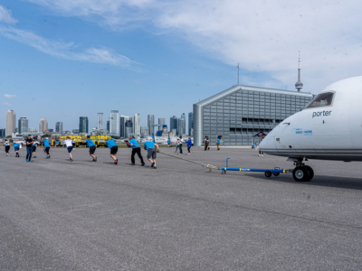 Des participants à Haul for Hope tirent un avion sur l’aire de trafic de l’aéroport.